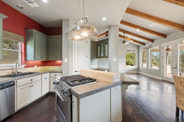 kitchen featuring visible vents, appliances with stainless steel finishes, open floor plan, vaulted ceiling with beams, and a sink