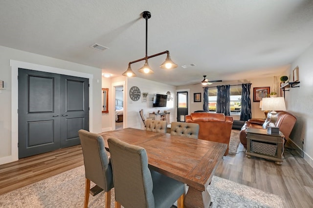 dining area featuring ceiling fan, baseboards, visible vents, and light wood-style floors