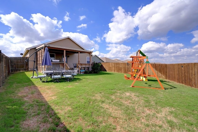 view of yard with a playground and a fenced backyard