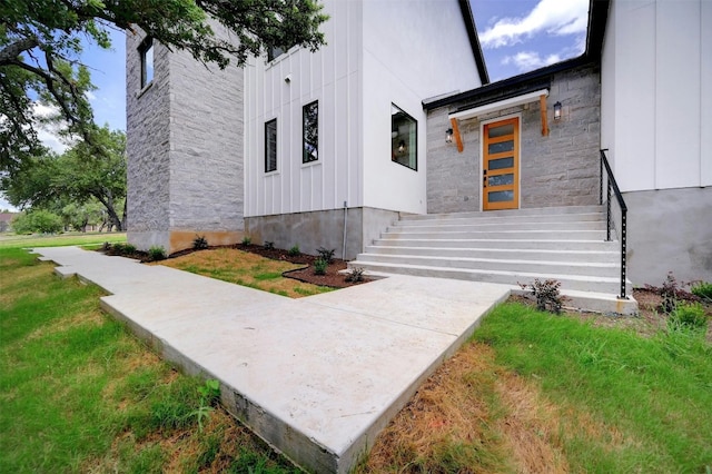 property entrance featuring board and batten siding