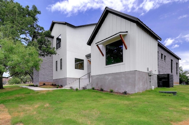 view of home's exterior featuring board and batten siding and a yard