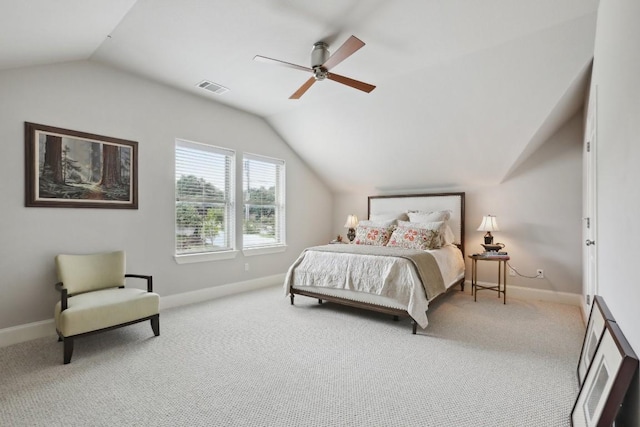 bedroom featuring vaulted ceiling, light carpet, visible vents, and baseboards
