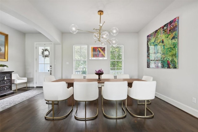 dining room with dark wood-style flooring, a notable chandelier, and baseboards