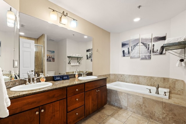 bathroom featuring toilet, tile patterned flooring, a sink, and a shower stall