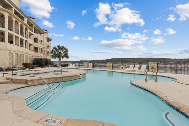 pool featuring a patio and fence