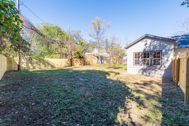 view of yard with a fenced backyard