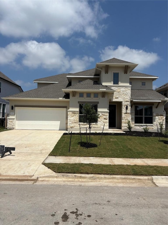 417 Hollister Dr, Liberty Hill, TX 78642 - prairie-style house with stone siding, stucco siding, driveway, and a garage