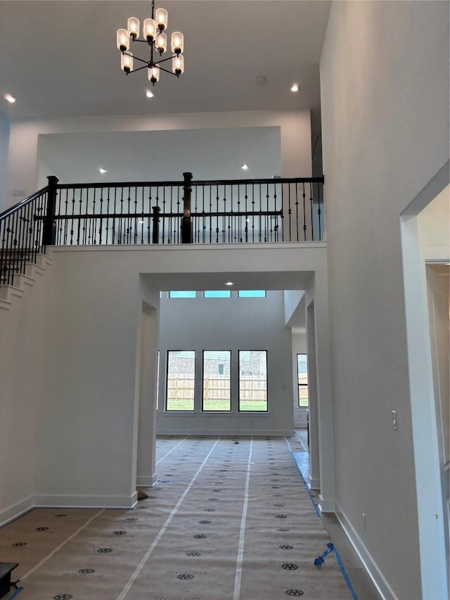 417 Hollister Dr, Liberty Hill, TX 78642 - foyer featuring plenty of natural light, a chandelier, baseboards, a towering ceiling, and recessed lighting