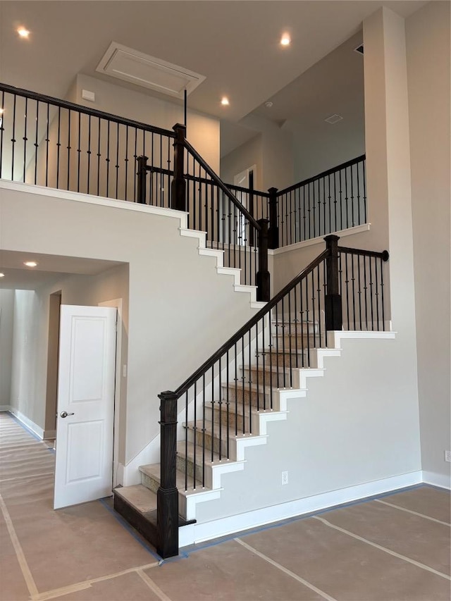 417 Hollister Dr, Liberty Hill, TX 78642 - stairs featuring a towering ceiling, baseboards, and recessed lighting