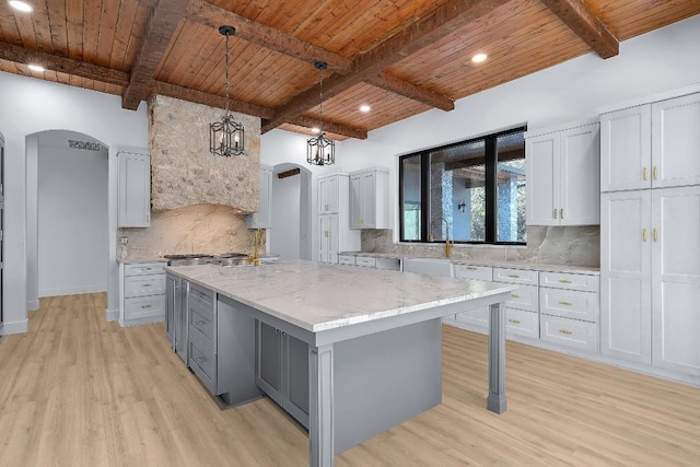 LOT34 Prancing Deer Ln, Johnson City, TX 78636 - kitchen with arched walkways, wooden ceiling, decorative light fixtures, and a center island