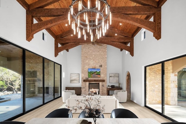 LOT34 Prancing Deer Ln, Johnson City, TX 78636 - living room with a chandelier, a stone fireplace, wood ceiling, and light wood-style floors