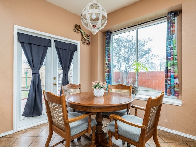 dining area featuring baseboards and tile patterned floors