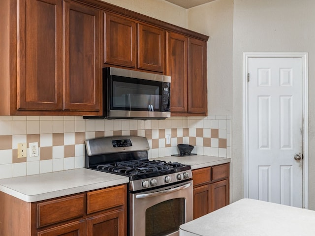 kitchen featuring brown cabinets, tasteful backsplash, appliances with stainless steel finishes, and light countertops