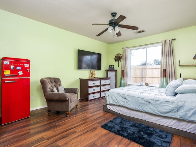 bedroom with ceiling fan, visible vents, baseboards, fridge, and dark wood-style floors