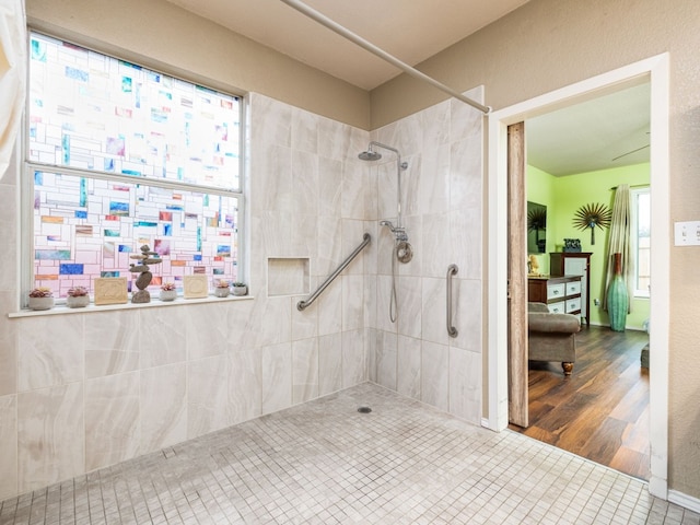 full bathroom featuring tile patterned flooring and tiled shower