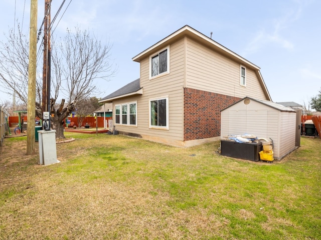 rear view of property featuring brick siding, a yard, an outdoor living space, and fence