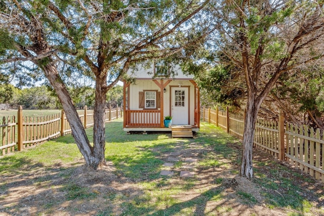 exterior space featuring a fenced backyard and an outbuilding