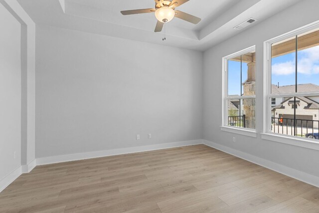 1109 Blanket Flower Dr, Georgetown, TX 78628 - unfurnished room with a raised ceiling, healthy amount of natural light, light wood finished floors, and ceiling fan