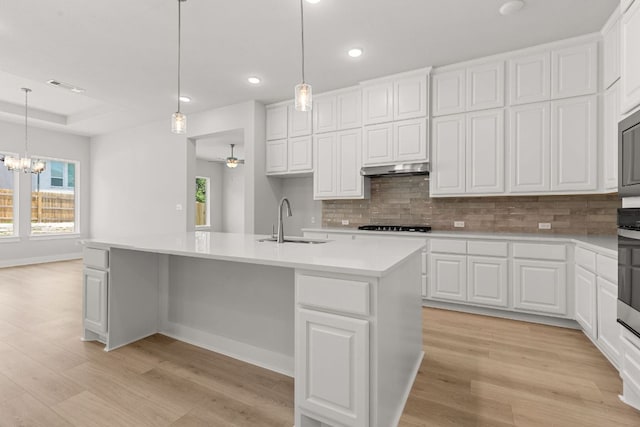 1109 Blanket Flower Dr, Georgetown, TX 78628 - kitchen featuring light wood-style flooring, decorative backsplash, light countertops, healthy amount of natural light, and recessed lighting