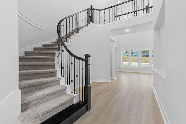 1109 Blanket Flower Dr, Georgetown, TX 78628 - staircase featuring wood finished floors and a towering ceiling