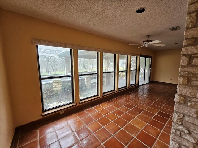 unfurnished sunroom with ceiling fan and visible vents