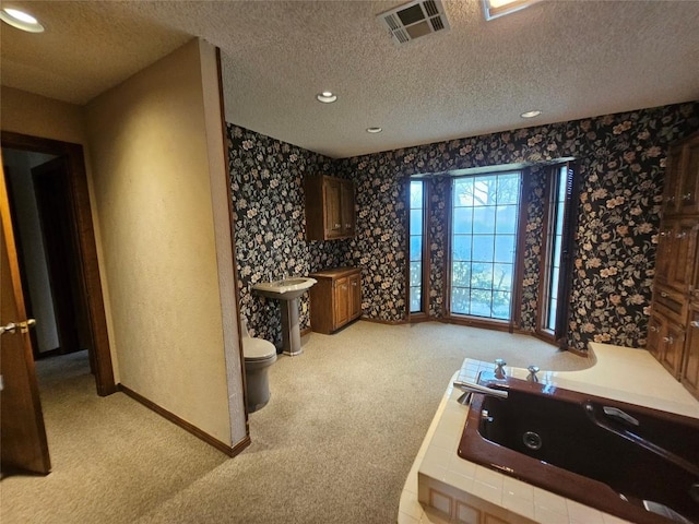 bathroom with toilet, wallpapered walls, visible vents, and a textured ceiling