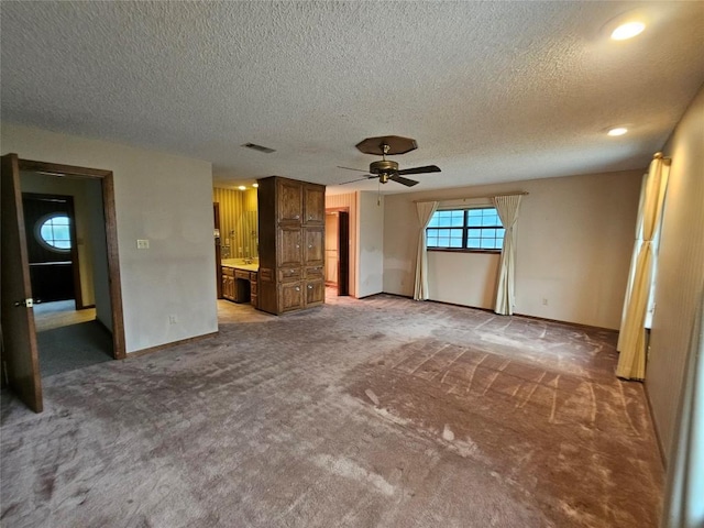 interior space with a ceiling fan, baseboards, visible vents, and carpet flooring