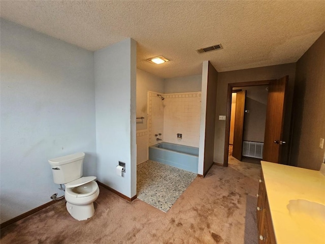 bathroom with toilet, a tub to relax in, vanity, and visible vents