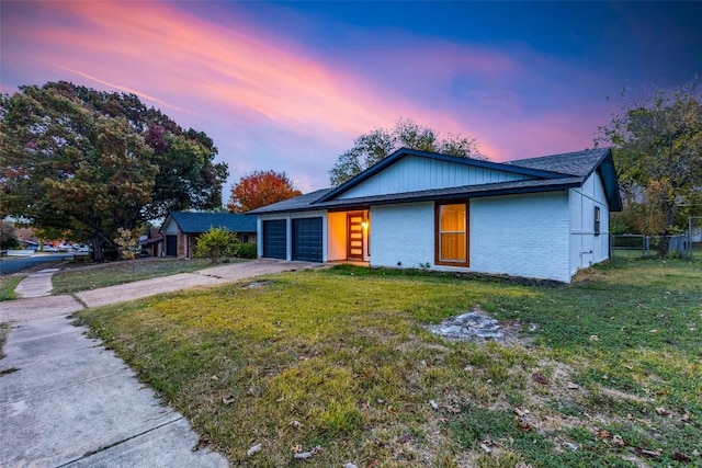 view of front of property with driveway, fence, and a front lawn