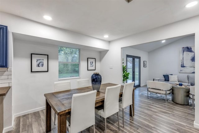 dining space with baseboards, french doors, wood finished floors, and recessed lighting