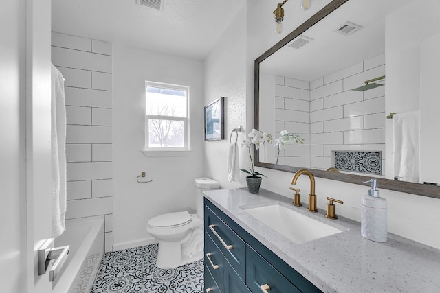 full bathroom with toilet, vanity, visible vents, and tile patterned floors