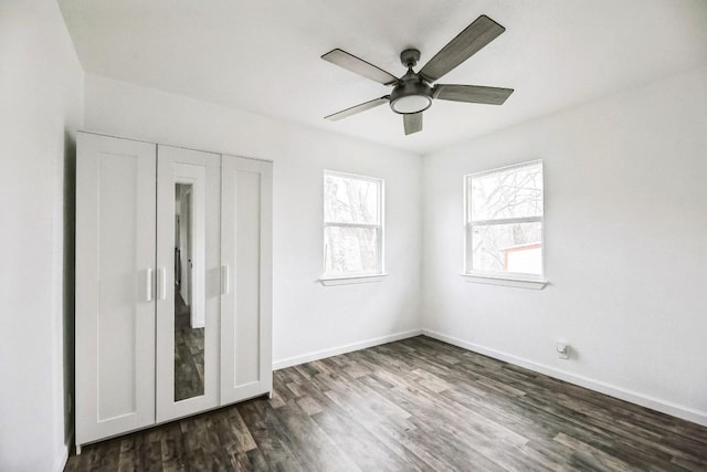 2905 Rogge Ln, Austin, TX 78723 - unfurnished bedroom with dark wood-style flooring and ceiling fan