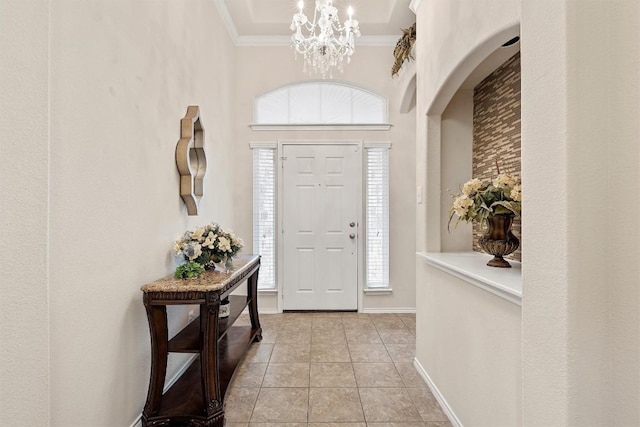 entryway with an inviting chandelier, crown molding, baseboards, and light tile patterned floors