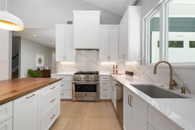 kitchen with white cabinets, visible vents, stainless steel appliances, and a sink