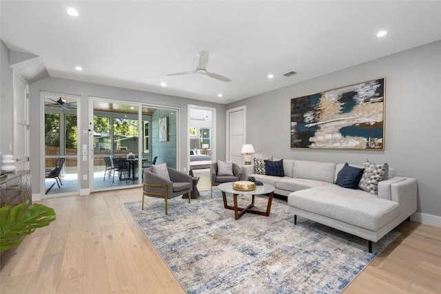 living room with a ceiling fan, recessed lighting, and light wood-style flooring