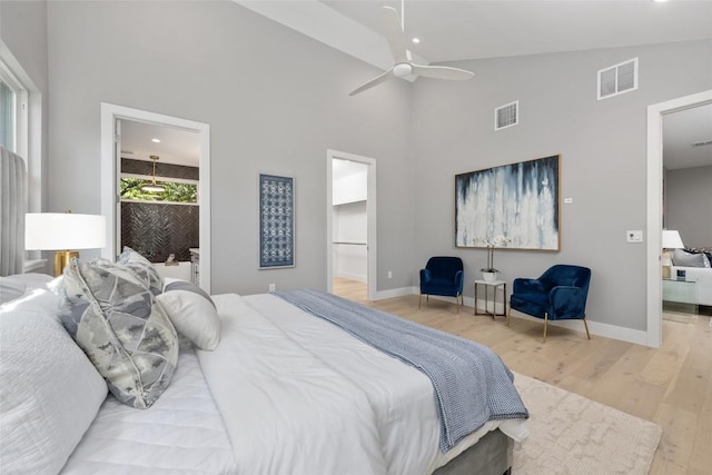 bedroom with baseboards, ensuite bath, visible vents, and light wood-style floors