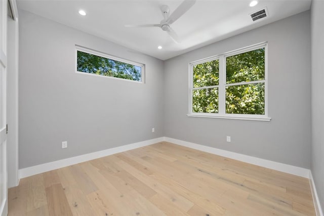 unfurnished room featuring light wood-type flooring, baseboards, visible vents, and recessed lighting