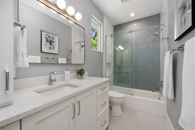 bathroom with visible vents, toilet, enclosed tub / shower combo, vanity, and tile patterned flooring