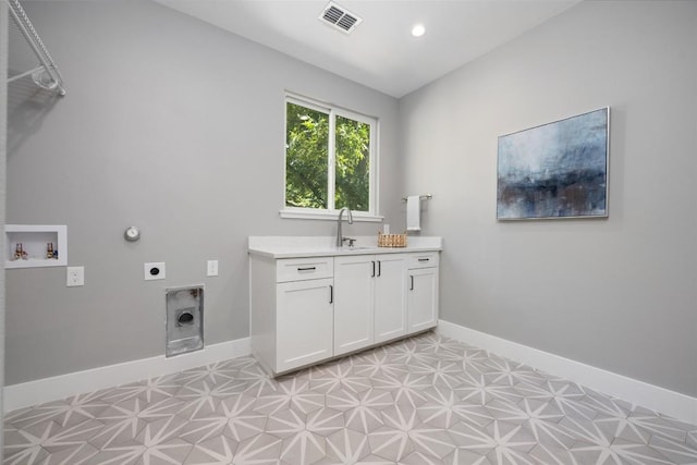 clothes washing area with baseboards, visible vents, hookup for an electric dryer, light floors, and a sink