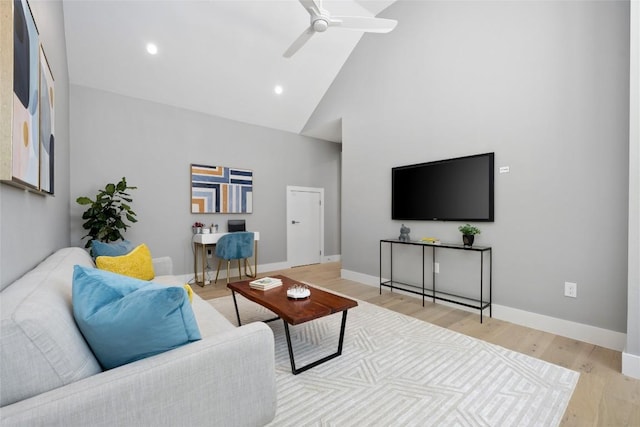 living room with ceiling fan, high vaulted ceiling, recessed lighting, baseboards, and light wood finished floors