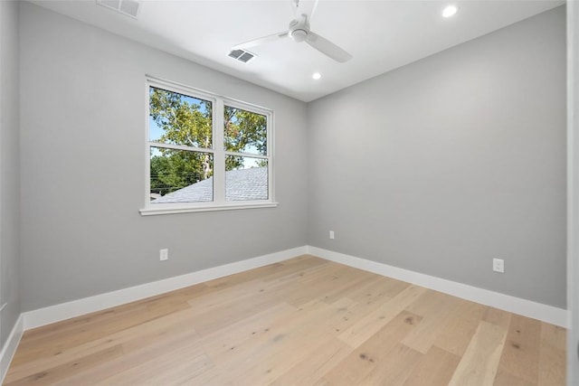 unfurnished room featuring a ceiling fan, visible vents, light wood-style flooring, and baseboards