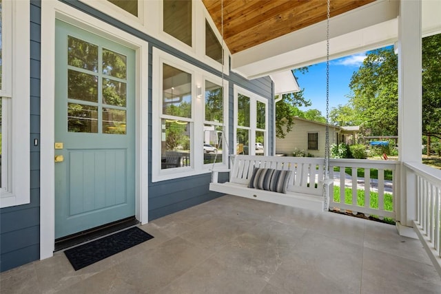 exterior space featuring wood ceiling and vaulted ceiling