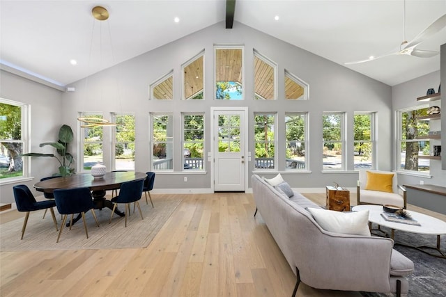 sunroom featuring vaulted ceiling with beams