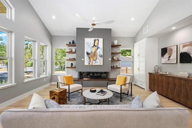 living area with high vaulted ceiling, recessed lighting, visible vents, baseboards, and light wood-type flooring