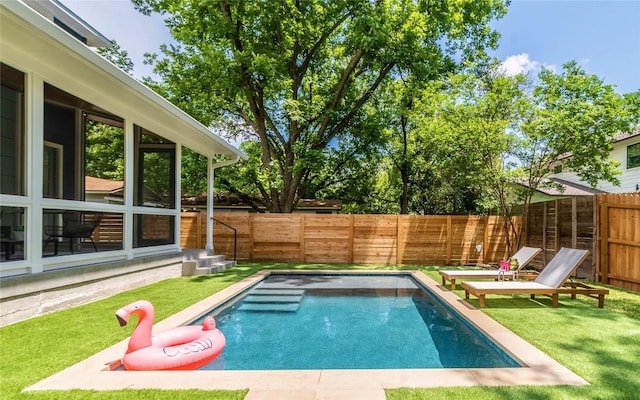 view of swimming pool featuring a fenced in pool, a fenced backyard, and a lawn