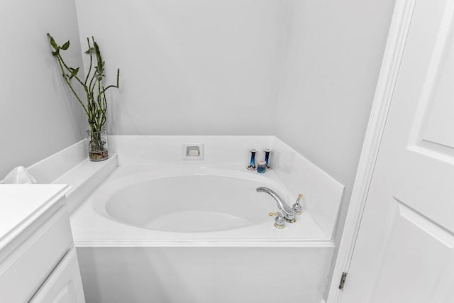 bathroom with a bath and vanity