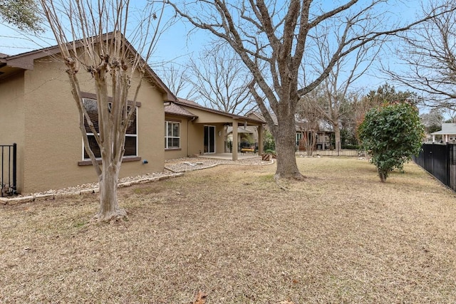 view of yard with fence and a patio