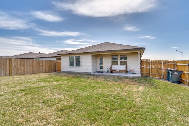 back of house with a patio, a yard, and a fenced backyard