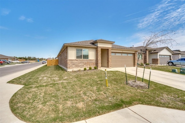 view of front of property featuring brick siding, an attached garage, a front yard, fence, and driveway