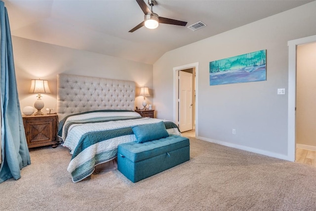 bedroom with light colored carpet, lofted ceiling, visible vents, and baseboards